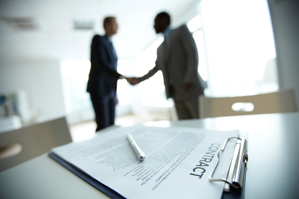 Image of a business deal handshake, featuring 411 Corporate Law and highlighting 'What Are Corporate Contracts?' to align with the page's context on corporate agreements and legal obligations.